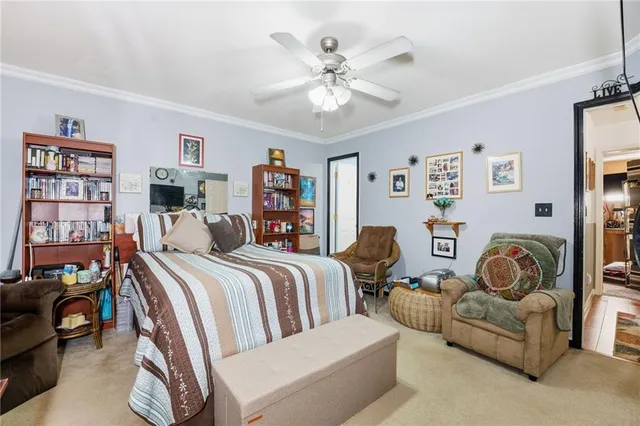 a bedroom with a bed a couch and a bookshelf