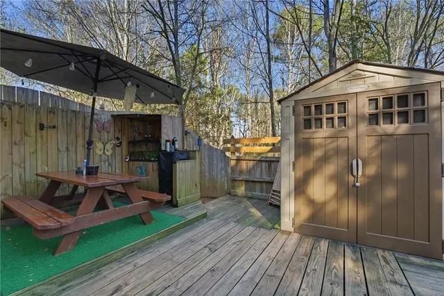 a view of a chairs and table on the wooden deck