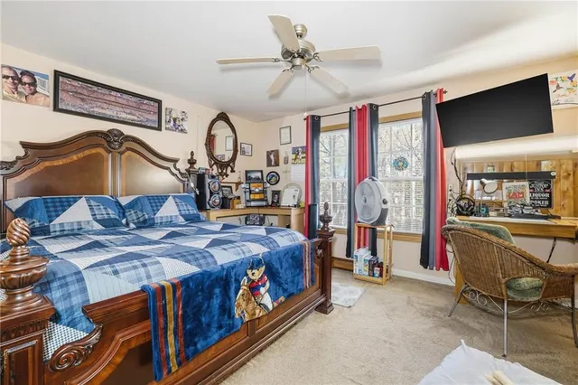 a bedroom with bed and glass door
