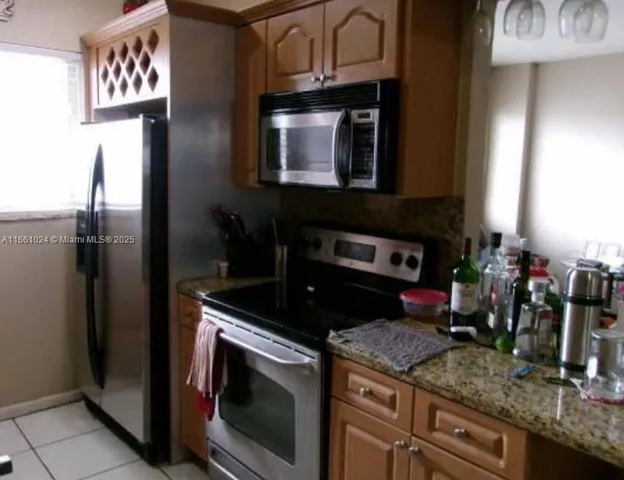 a kitchen with a stove and a microwave