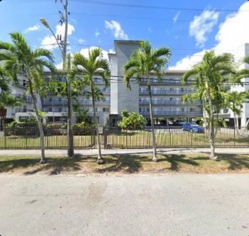 a view of a house with a yard and a fountain