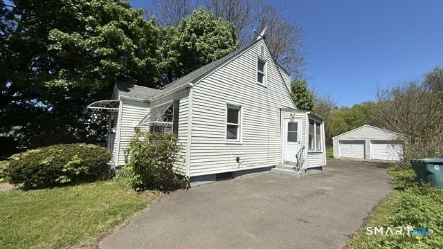 131 Bryden Terrace Hamden, CT 06517 - Photo 2 of 16 a view of a house with a yard and garage