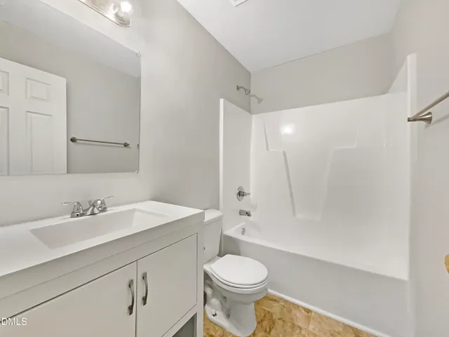 a bathroom with a sink toilet a mirror and shower