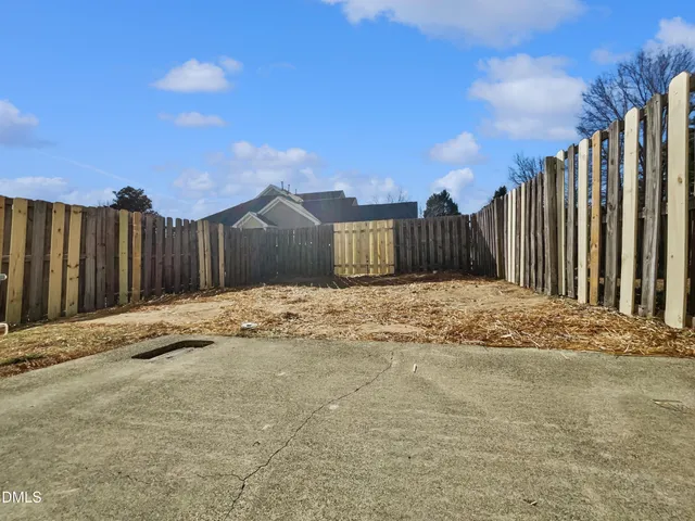 a view of large house with wooden fence