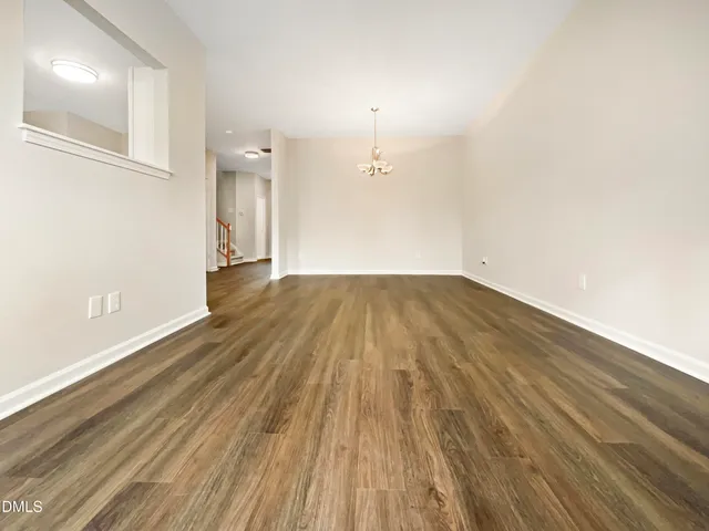 a view of a room with wooden floor