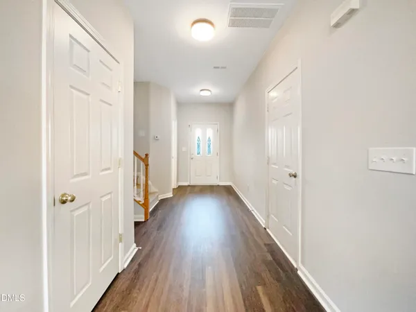 a view of a hallway with wooden floor