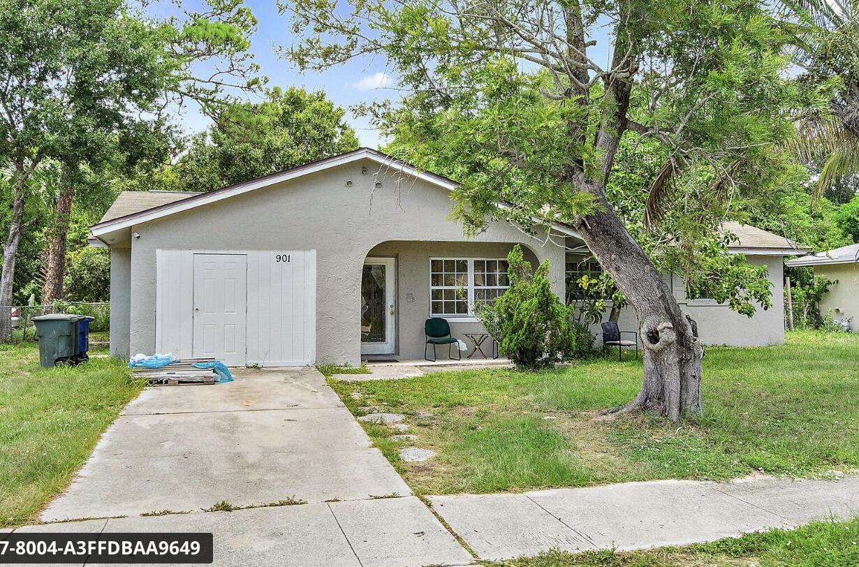 901 Hickory Street, Unit A Fort Pierce, FL 34947 - Photo 1 of 7 a front view of a house with a yard