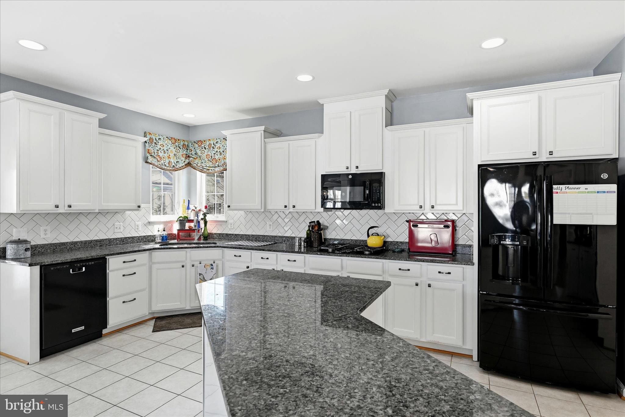 105 Garret Court Stephenson, VA 22656 - Photo 24 of 97 a kitchen with stainless steel appliances granite countertop a sink stove and refrigerator