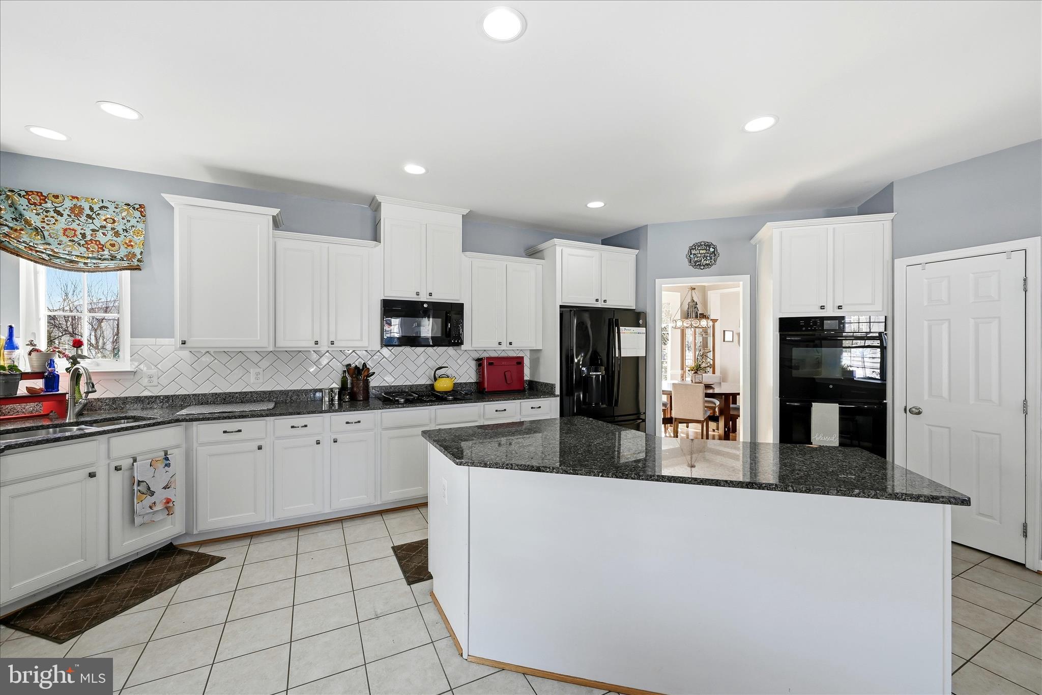 105 Garret Court Stephenson, VA 22656 - Photo 27 of 97 a kitchen with stainless steel appliances granite countertop a refrigerator sink stove microwave and cabinets