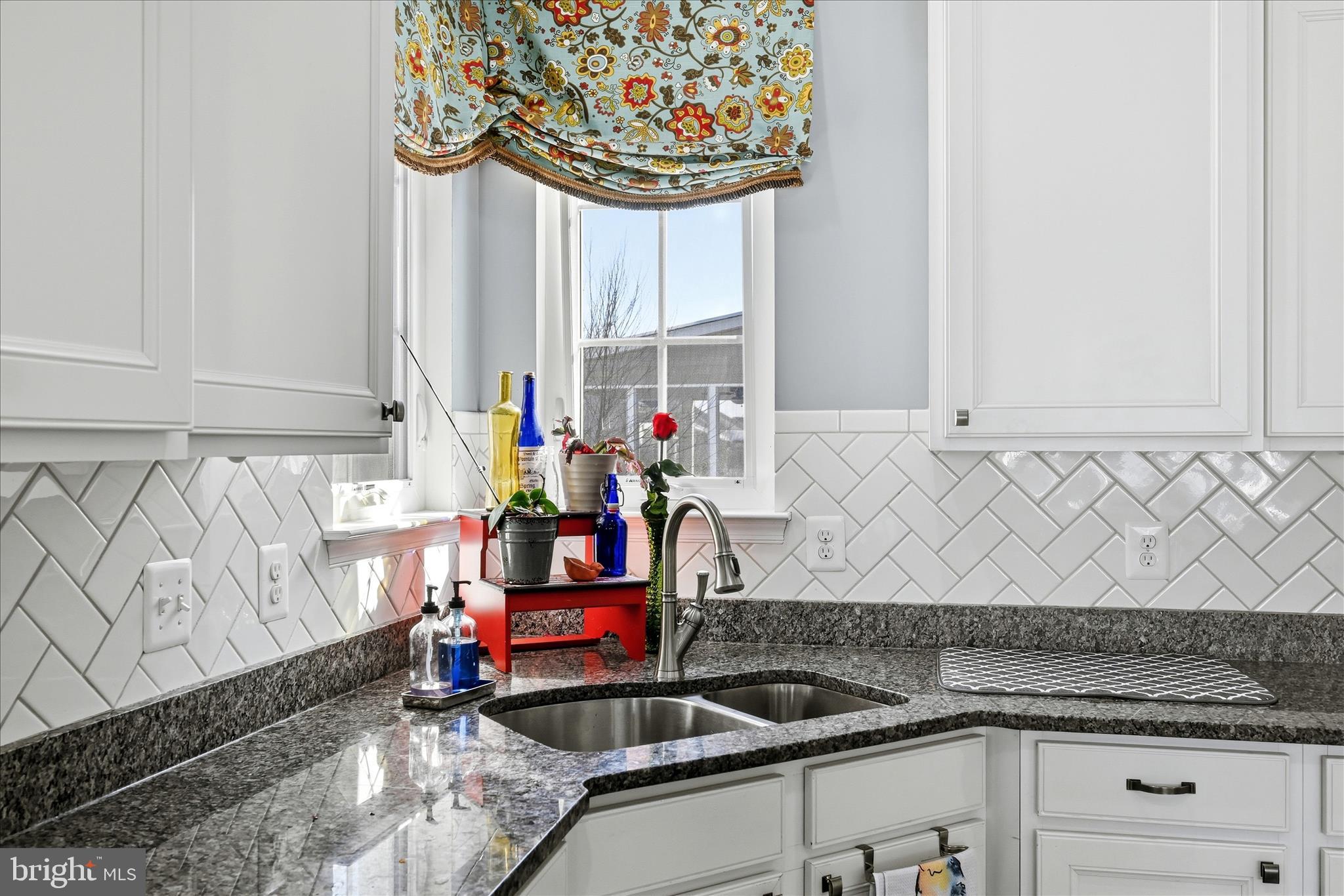 105 Garret Court Stephenson, VA 22656 - Photo 29 of 97 a kitchen with a sink and a stove next to a window