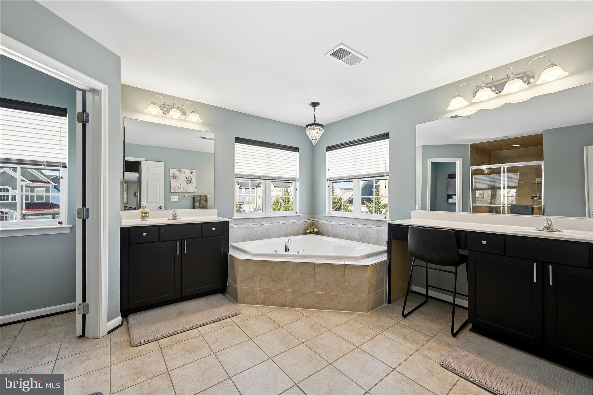 105 Garret Court Stephenson, VA 22656 - Photo 36 of 97 a spacious bathroom with a double vanity sink bathtub large mirror and window