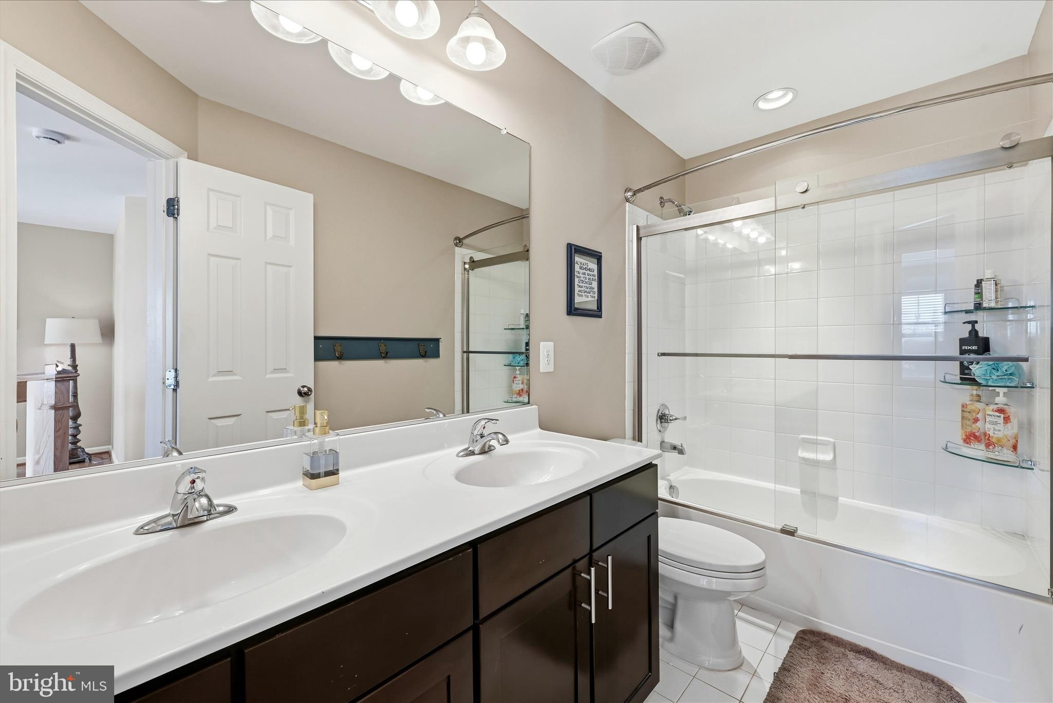 105 Garret Court Stephenson, VA 22656 - Photo 47 of 97 a bathroom with a sink a toilet a shower and a mirror