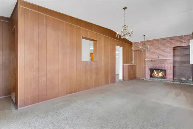 a view of a livingroom with a fireplace and window