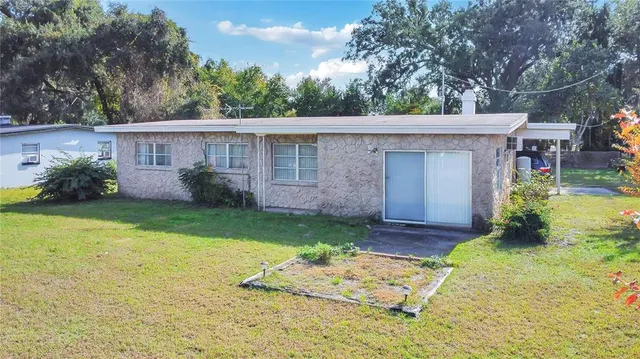 an aerial view of a house with a swimming pool yard and outdoor seating