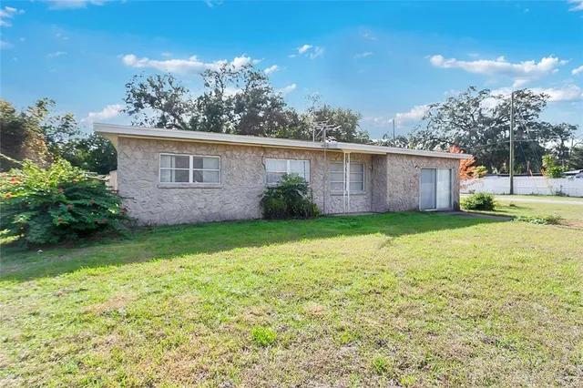 a view of a house with yard and a garden