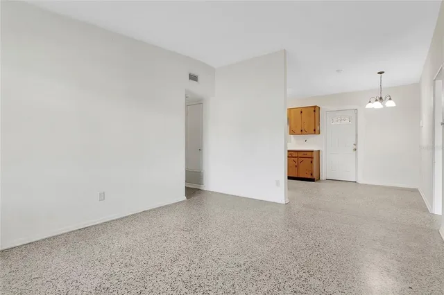 an empty room with a cabinet and mirror
