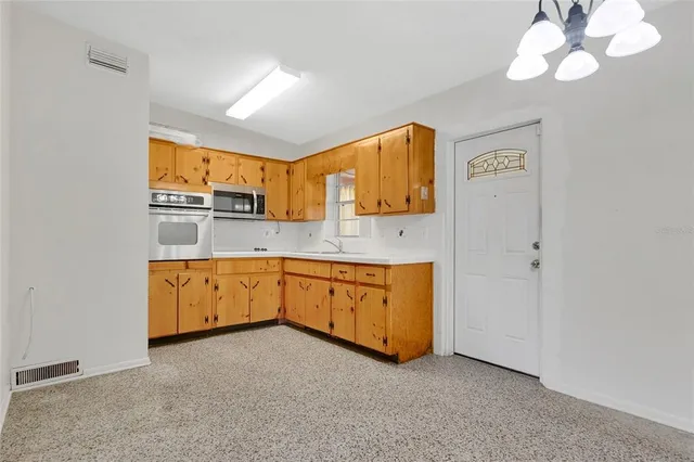 a kitchen with stainless steel appliances granite countertop a granite counter tops and a window