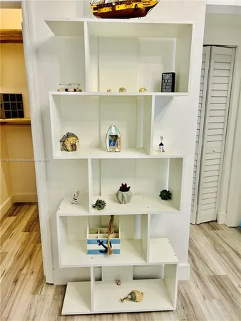 a room with a wooden floor and shoes