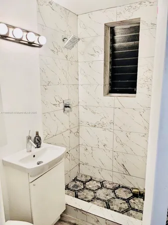 a bathroom with a sink and a shower