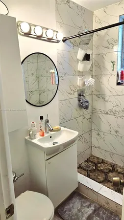 a bathroom with a sink toilet and shower