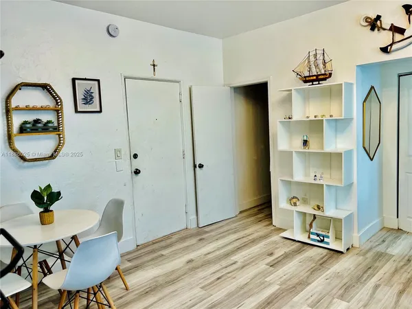 a view of a livingroom with furniture and mirror