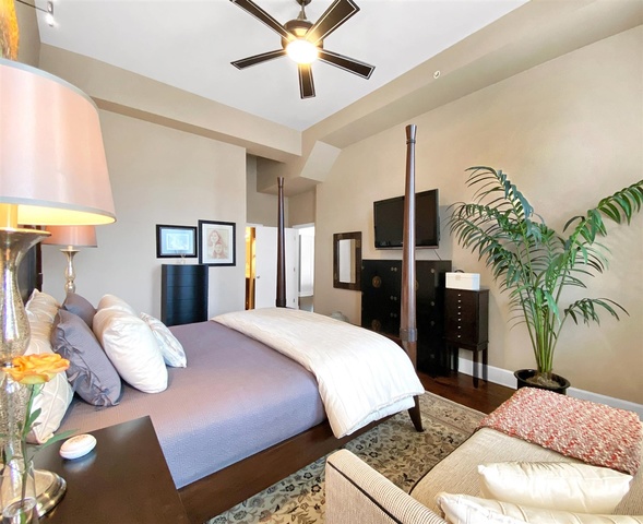 165 North Canal Street, Unit 1412 Chicago, IL 60606 - Photo 23 of 38 a bed room with a bed and a chandelier