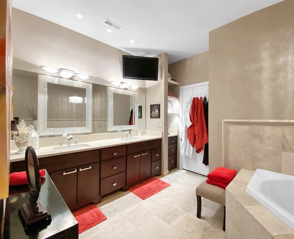 165 North Canal Street, Unit 1412 Chicago, IL 60606 - Photo 24 of 38 a spacious bathroom with a tub sink and mirror