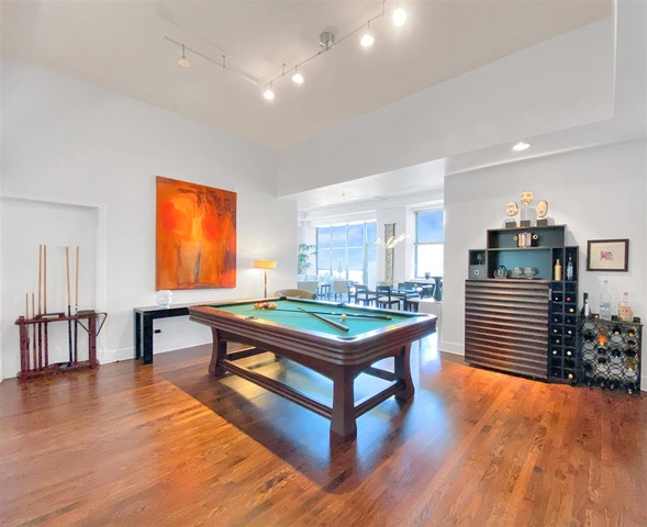 165 North Canal Street, Unit 1412 Chicago, IL 60606 - Photo 8 of 38 a room with furniture pool table wooden floor and windows