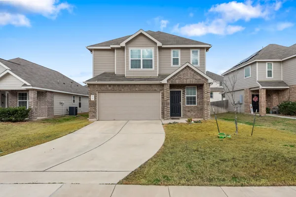 a front view of a house with a yard