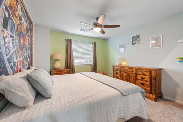 a bedroom with a large bed and a chandelier