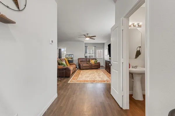 a view of entryway and hall with wooden floor