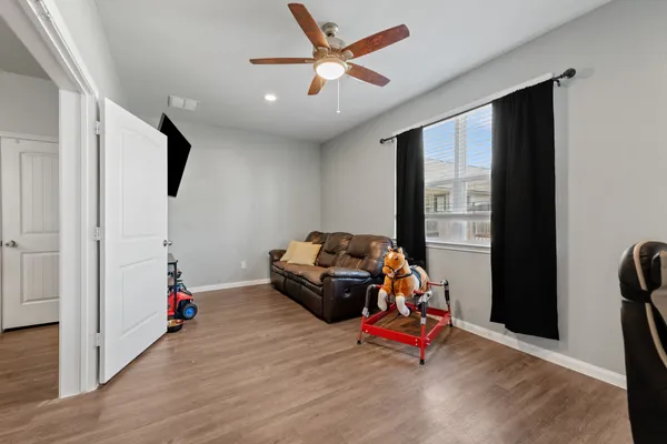a bedroom with furniture and a ceiling fan