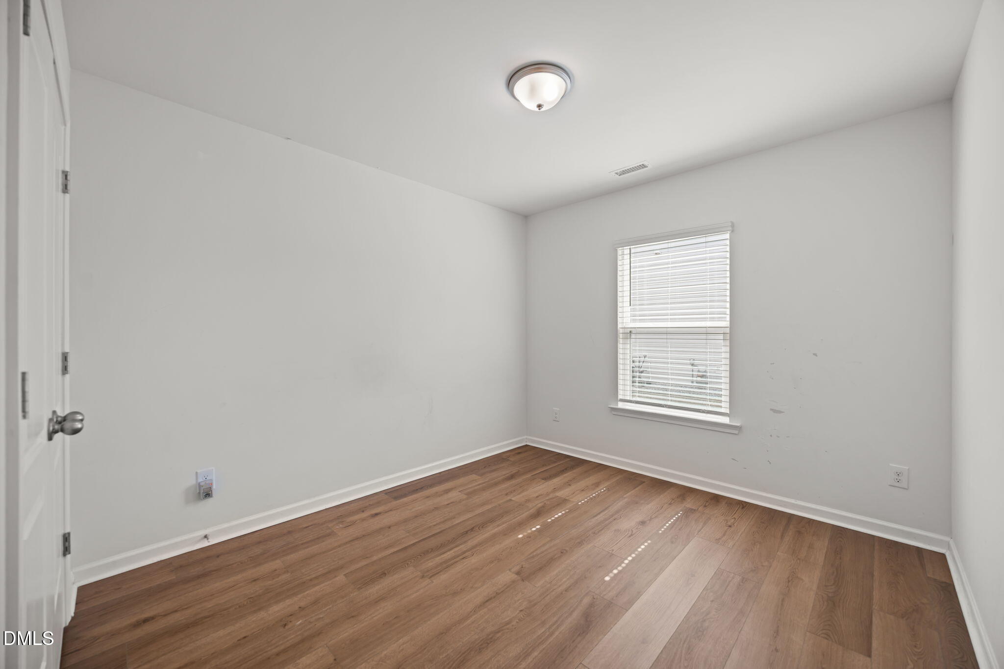 229 Summer Ranch Drive Fuquay-Varina, NC 27526 - Photo 11 of 35 an empty room with wooden floor and windows