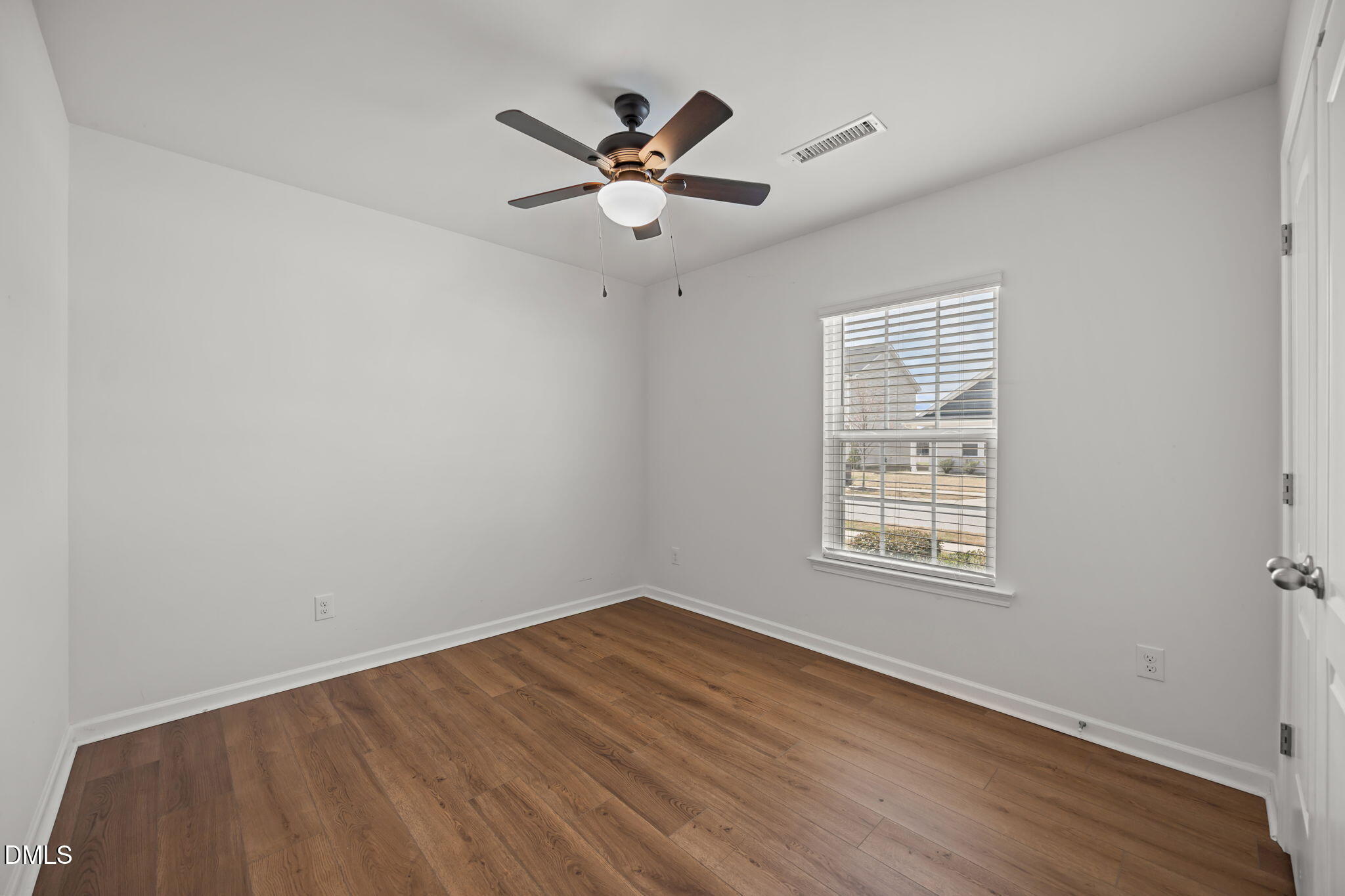 229 Summer Ranch Drive Fuquay-Varina, NC 27526 - Photo 12 of 35 an empty room with wooden floor fan and windows