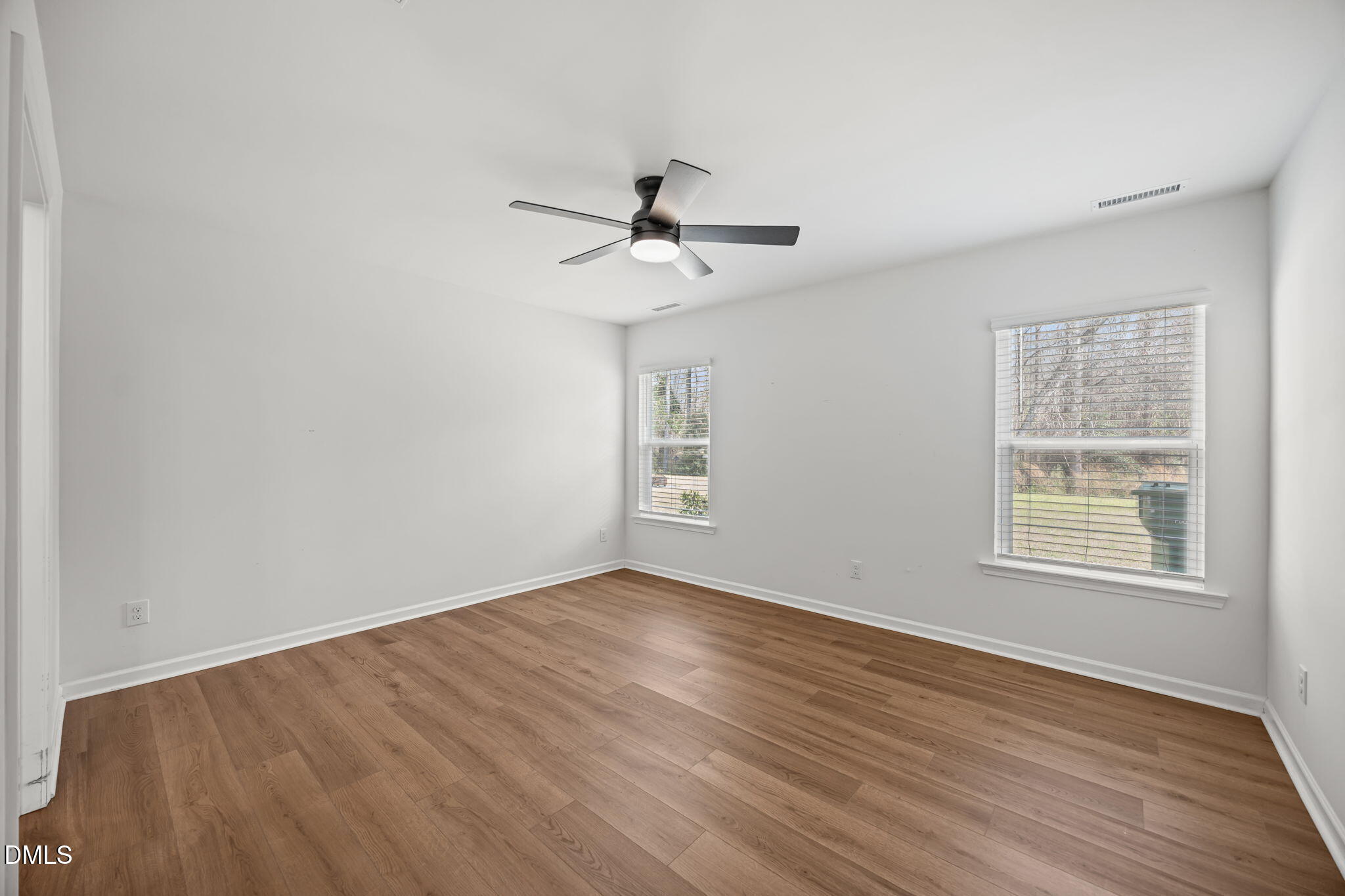 229 Summer Ranch Drive Fuquay-Varina, NC 27526 - Photo 15 of 35 an empty room with wooden floor ceiling fan and windows