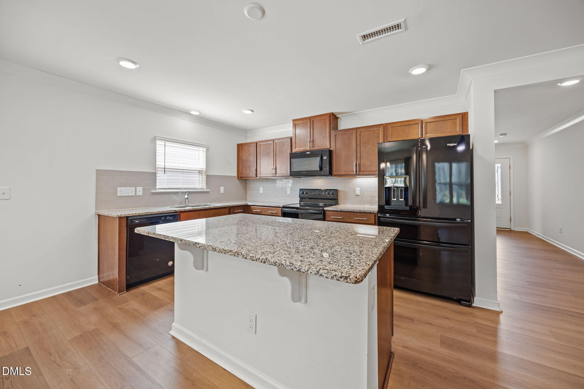 229 Summer Ranch Drive Fuquay-Varina, NC 27526 - Photo 2 of 35 a kitchen with stainless steel appliances granite countertop a refrigerator a stove and a sink