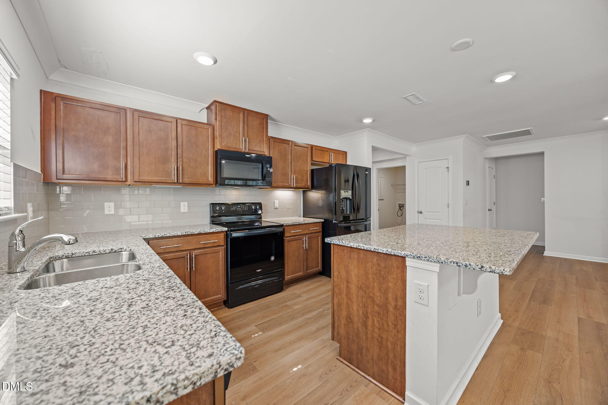 229 Summer Ranch Drive Fuquay-Varina, NC 27526 - Photo 3 of 35 a kitchen with stainless steel appliances granite countertop a sink stove and refrigerator