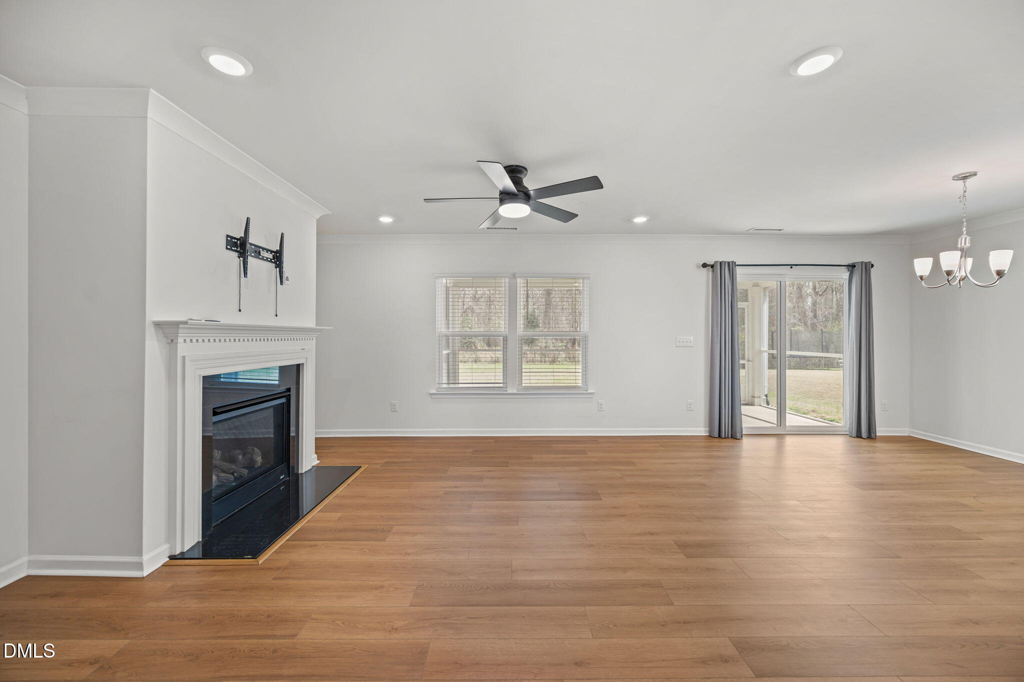 229 Summer Ranch Drive Fuquay-Varina, NC 27526 - Photo 4 of 35 a view of an empty room with a fireplace and a window