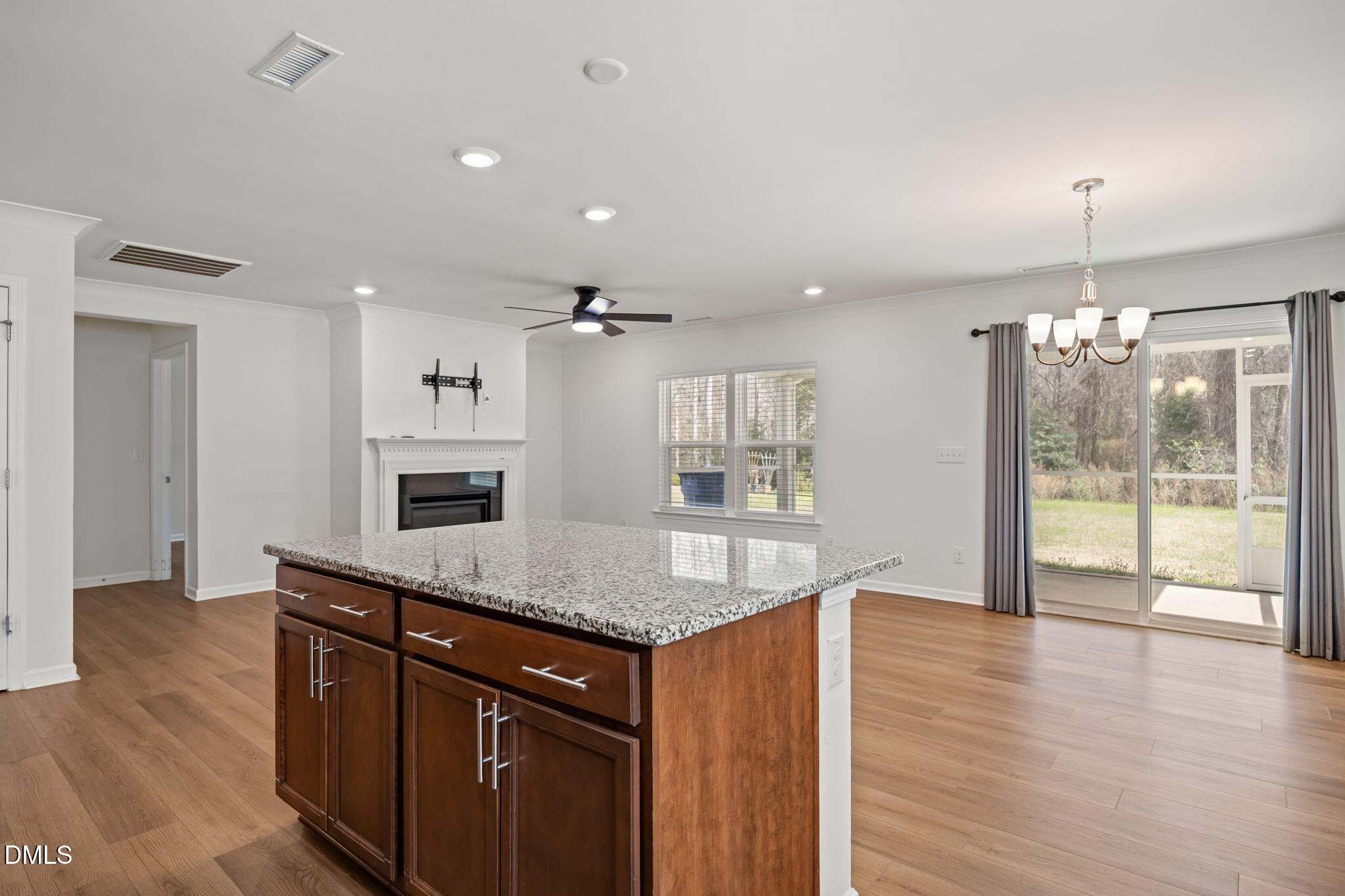 229 Summer Ranch Drive Fuquay-Varina, NC 27526 - Photo 6 of 35 a kitchen with stainless steel appliances granite countertop a refrigerator a sink and a wooden floors