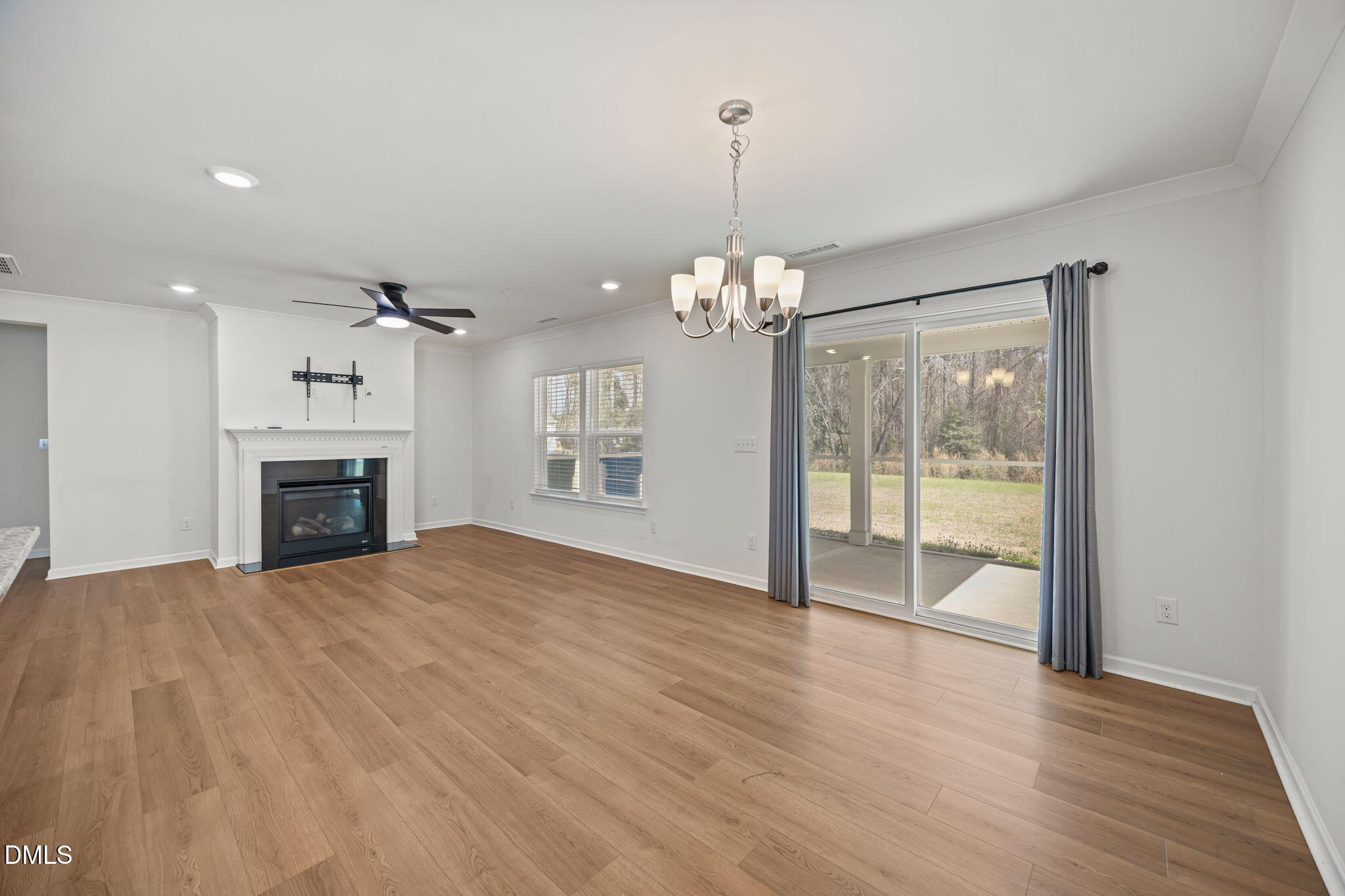 229 Summer Ranch Drive Fuquay-Varina, NC 27526 - Photo 9 of 35 a view of empty room with wooden floor and fireplace