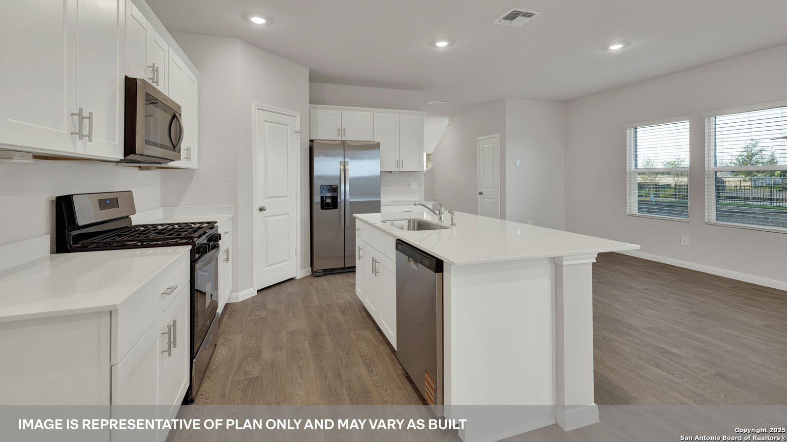 141 Raymondville Path San Marcos, TX 78666 - Photo 11 of 46 a kitchen with stainless steel appliances a sink a stove a microwave a refrigerator a window