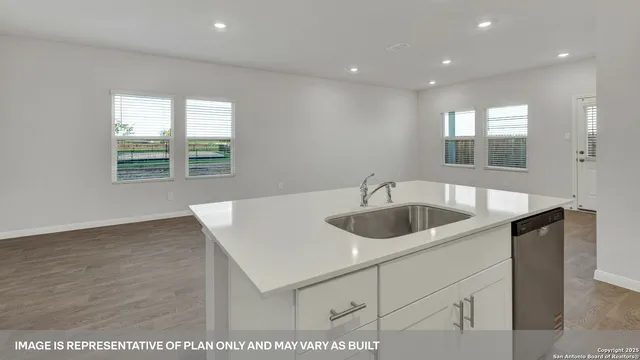 a view of an empty room with kitchen