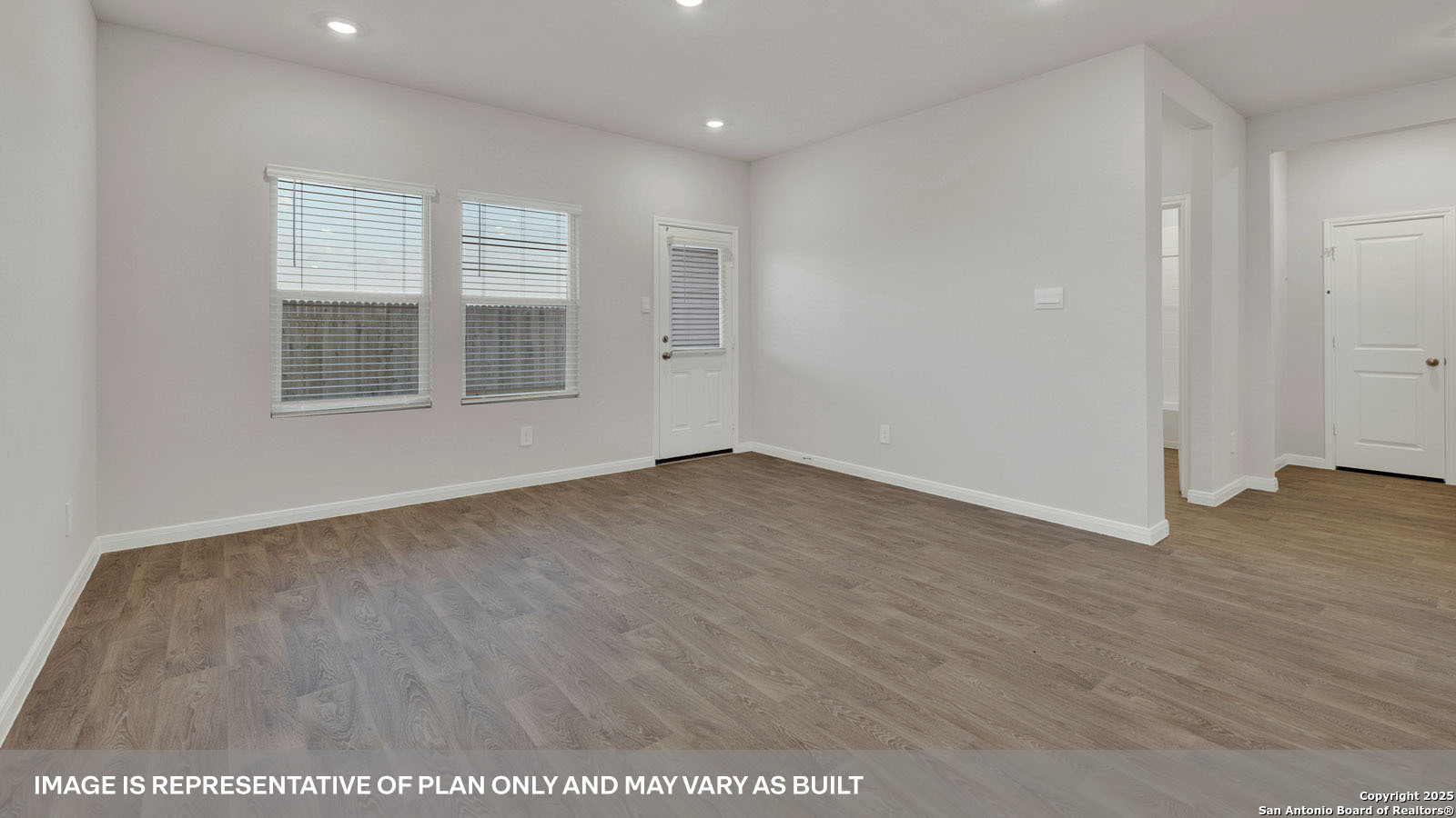 141 Raymondville Path San Marcos, TX 78666 - Photo 16 of 46 an empty room with wooden floor and windows