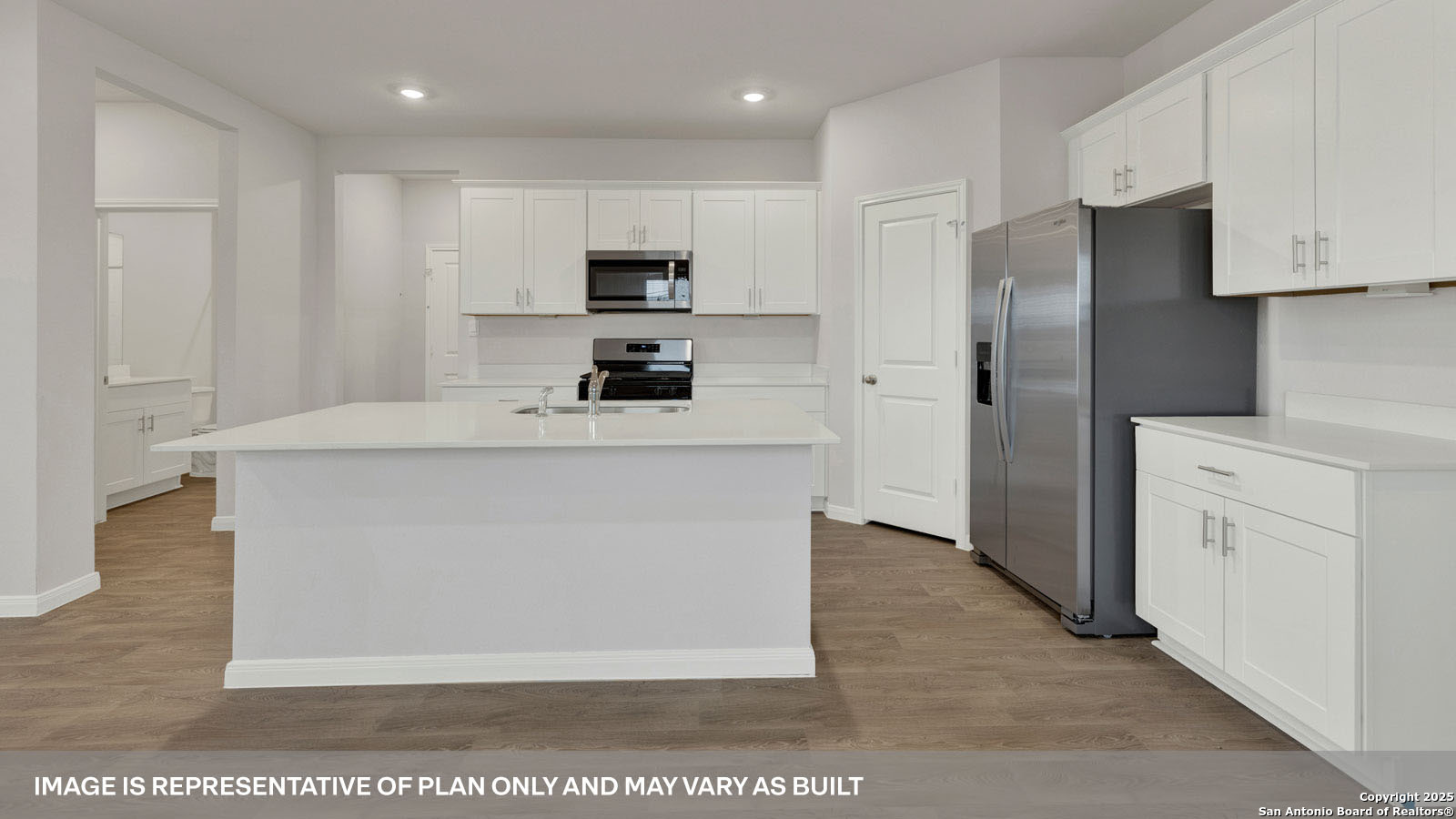 141 Raymondville Path San Marcos, TX 78666 - Photo 9 of 46 a kitchen with stainless steel appliances a refrigerator sink and white cabinets