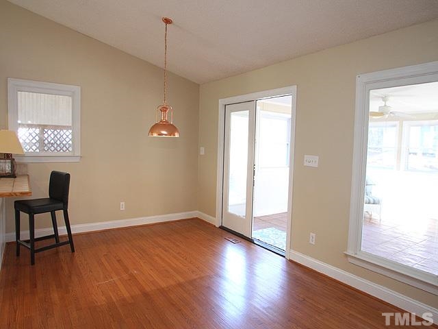 GREAT OVERHANGING BAR AREA FOR EXTRA SEATING AND THE DINING AREA OVERLOOKS THE SUNROOM AND LARGE BACKYARD!