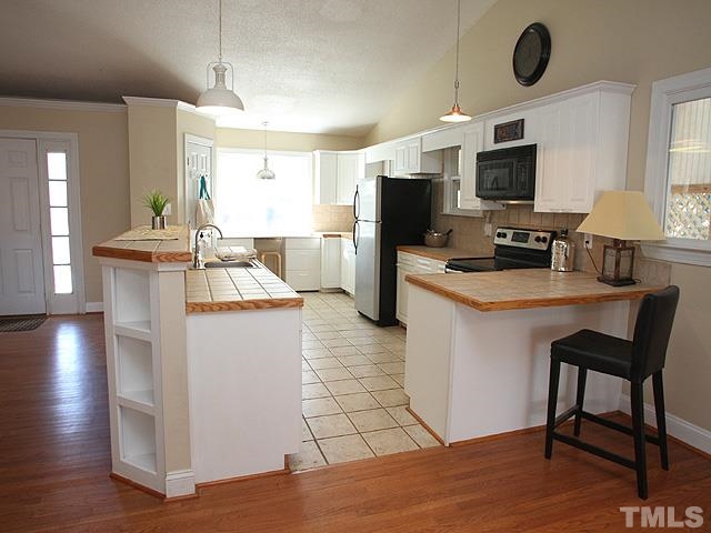 HUGE KITCHEN AREA WITH LOADS OF COUNTERTOP AND CABINET SPACE. LARGE WALK IN PANTRY AND A BUILT IN WORKSPACE DESK AREA MAKE THIS KITCHEN VERY FUNCTIONAL!
