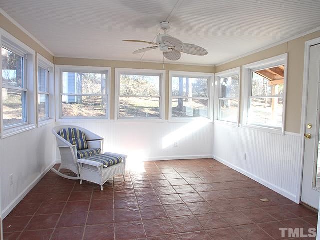 FRESHLY PAINTED SUNROOM THAT HAS ALL IT'S PERMITS AND OVERLOOKS THE LARGE DECK AND NATURAL BACKYARD. FANTASTIC FOR ENTERTAINING!