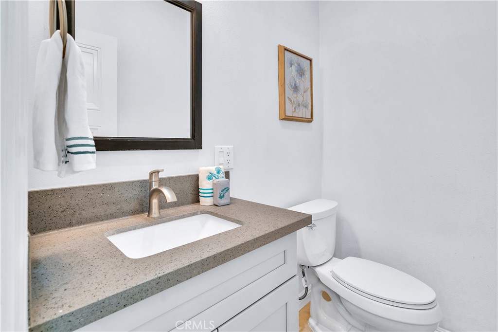 511-unit 1 Alvarado Street Redlands, CA 92373 - Photo 14 of 56 a bathroom with a granite countertop toilet sink and mirror