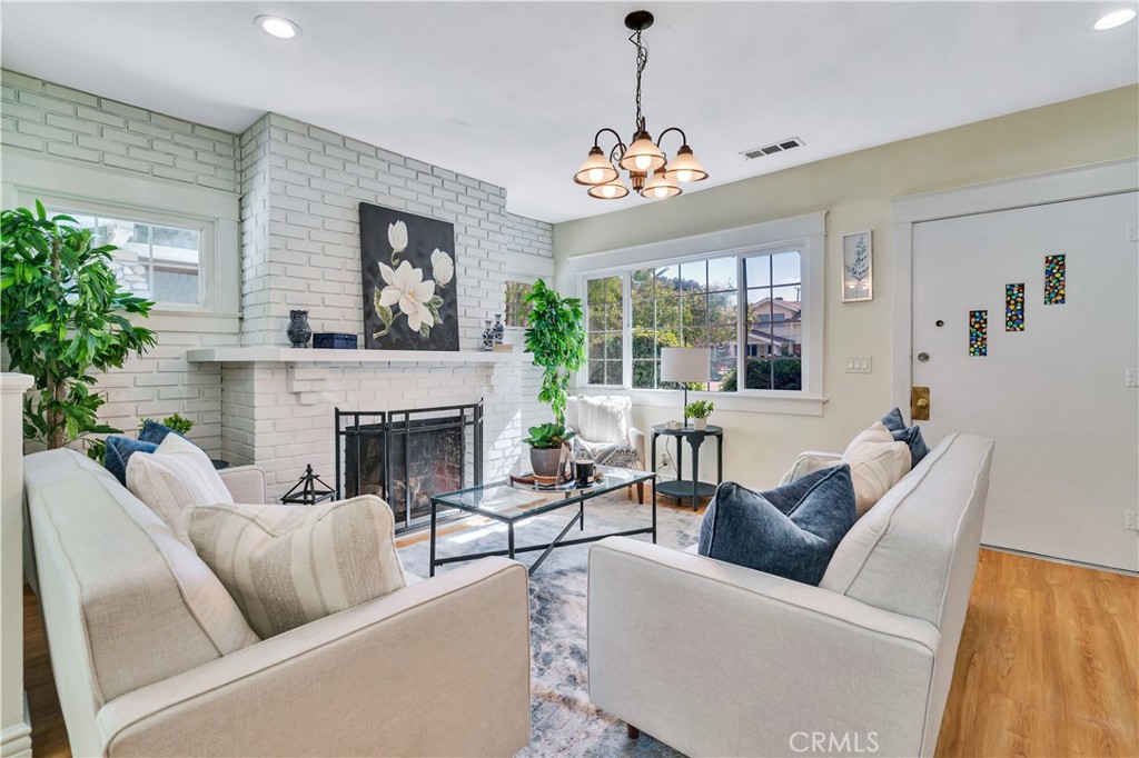 511-unit 1 Alvarado Street Redlands, CA 92373 - Photo 2 of 56 a living room with furniture a chandelier and a fireplace