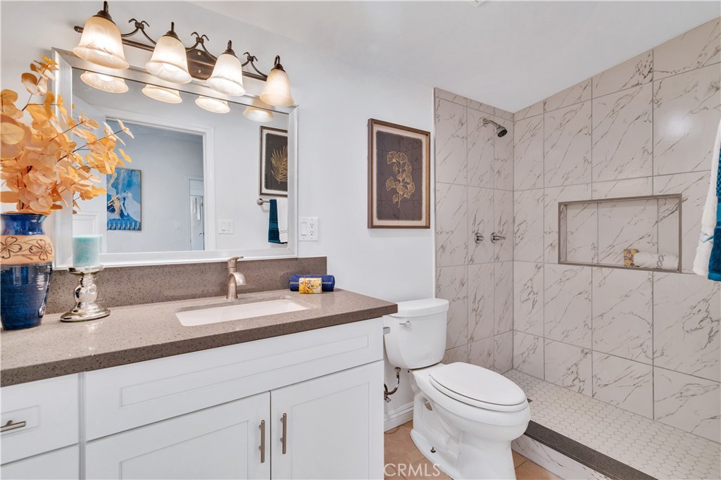 511-unit 1 Alvarado Street Redlands, CA 92373 - Photo 21 of 56 a bathroom with a granite countertop sink mirror vanity and toilet
